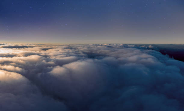istock Thick layer of white clouds above mountains at sunrise 1365175372