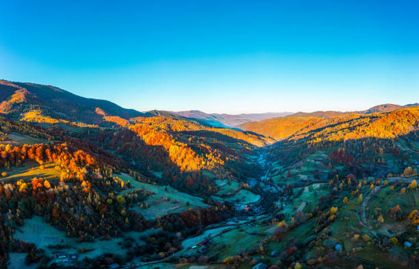 istock Shaded mountain valley with houses and forests at sunset 1365175411