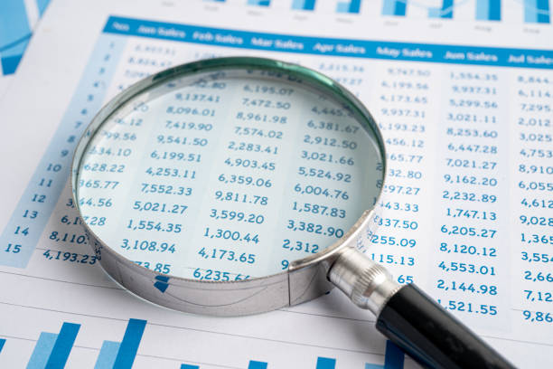 istock Magnifying glass on charts graphs paper. Financial development, Banking Account, Statistics, Investment Analytic research data economy, Stock exchange trading, Business office company meeting concept. 1365177559