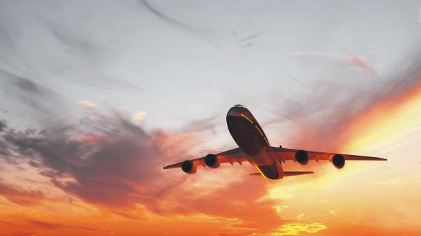 暖かい日差しで日没時に離陸する民間航空機 - airplane taking off sky commercial airplane ストックフォトと画像