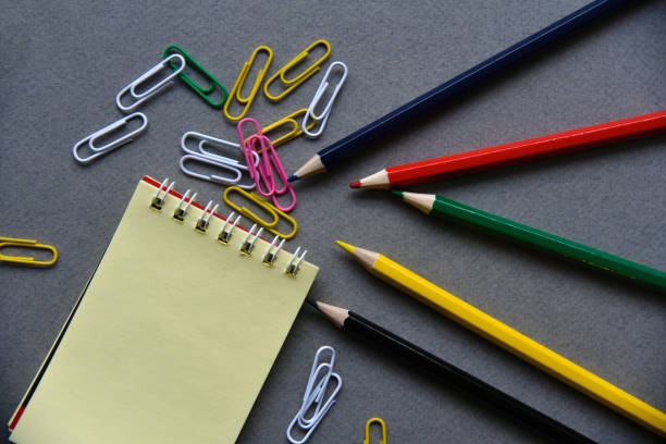 istock Pencils notepad and paper clips on the office desk 1365179756