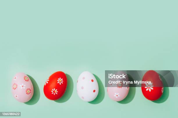 Easter Greeting Card Red And Pink Easter Eggs On Pastel Mint Background With Copy Space For Text Flat Lay Selective Focus Stock Photo - Download Image Now