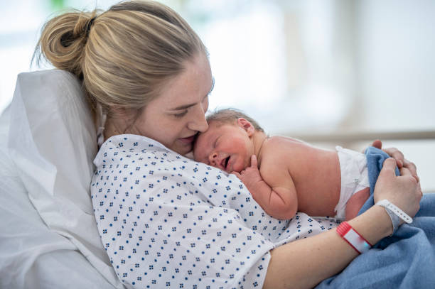 istock Hugging her new born baby 1365180966