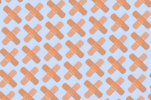 istock Pattern of Adhesive Bandages on Blue Background 1365184449