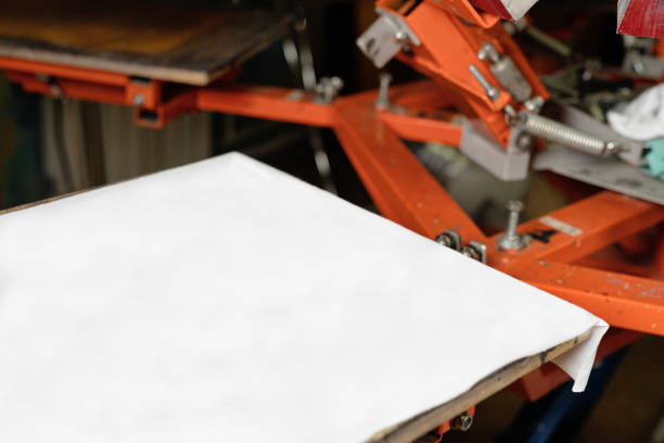 istock white cloth with copy space. silk screen printmaking. creating print on t-shirt in workshop 1365185281