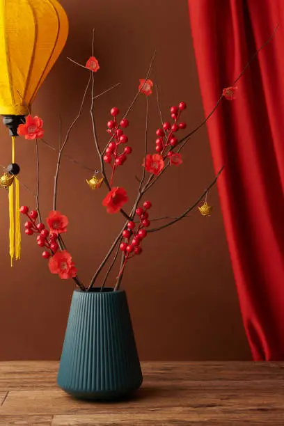 Vase with branches with red flowers traditional for Tet celebration in Vietnam