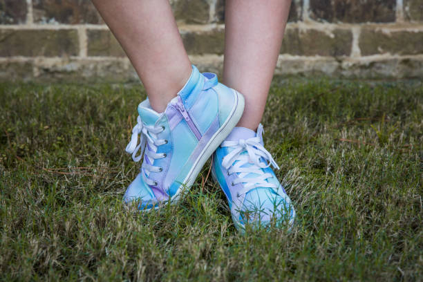 Girl wearing blue and purple tie-dye high-top tennis shoes outside Girl wearing blue and purple tie-dye high-top tennis shoes outside high tops stock pictures, royalty-free photos & images