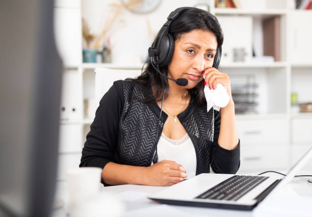 istock Upset woman wearing microphone headset at workplace in office 1365190266