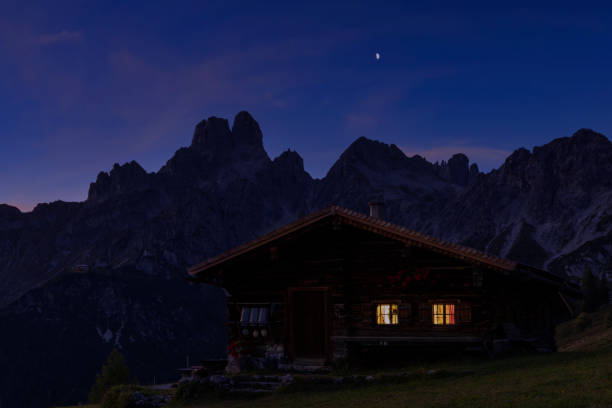 istock Alpine hut in the alps at night 1365192576
