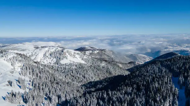 Aerial scenic rural view of the winter landscape from Kopaonik in Serbia. High-altitude aerial shot. Extreme hiking in European mountains.