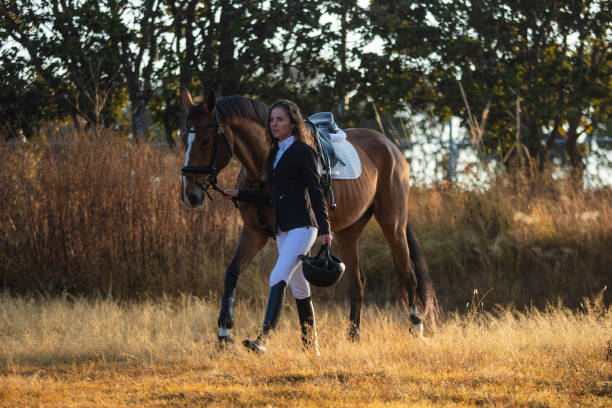 istock Young woman walking with her horse 1365193453