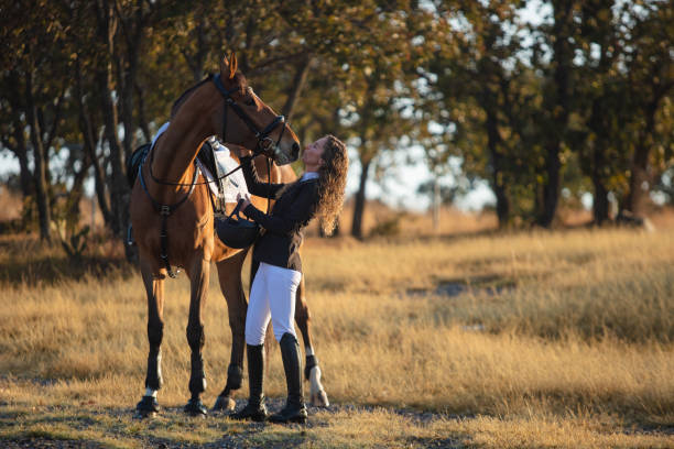 istock Young woman standing next to her horse 1365193459