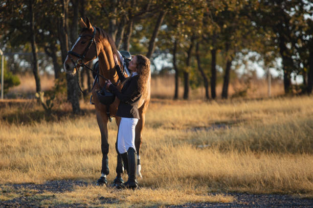 istock Young woman standing next to her horse 1365194090
