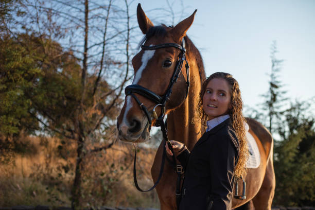 istock Young woman petting her horse 1365194193