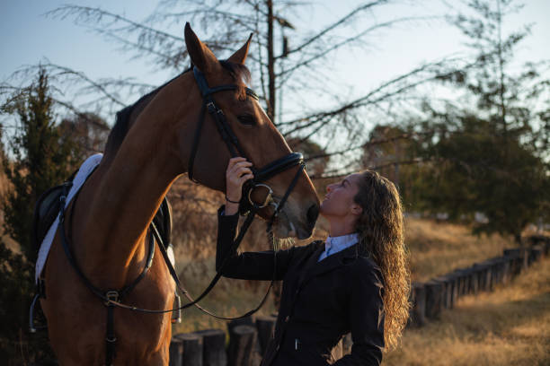 istock Young woman next to her horse 1365194334