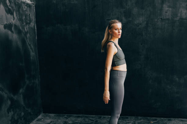 istock Active Lifestyle: Beautiful Fit Woman Warming up for a Workout, Looking at Camera 1365195898