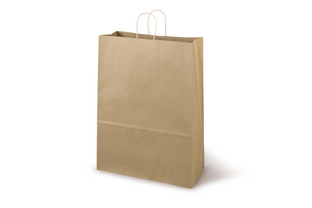 istock Brown craft small paper bag packaging template isolated on white background. Stand-up pouch side view package. Brown shopping bag mockup. Package with handle for shopping, advertising and branding 1365196412