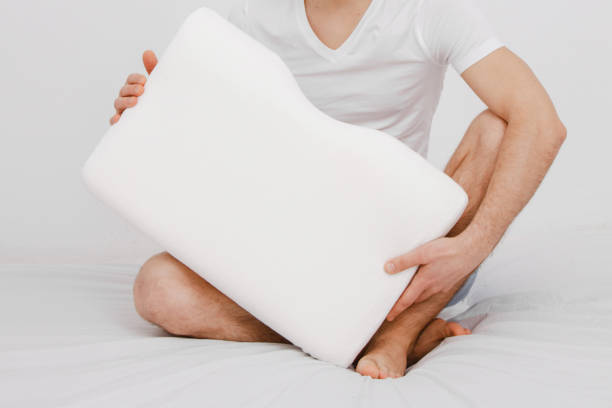 istock Orthopedic Pillow with a Memory Effect. Medical treatment pillow for sleep. Comfort Memory Pillow under the head with a recess under the shoulder isolated on white background. Sleeping Support Pillow 1365198143
