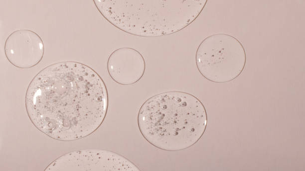 istock Background from cosmetic gel drops with bubbles.Top view,antibacterial liquid surface.Good as background or mockup,large banner. 1365198189