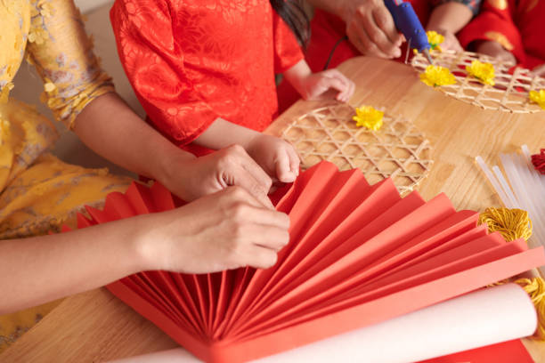 istock Woman Making Red Paper Fan 1365198989