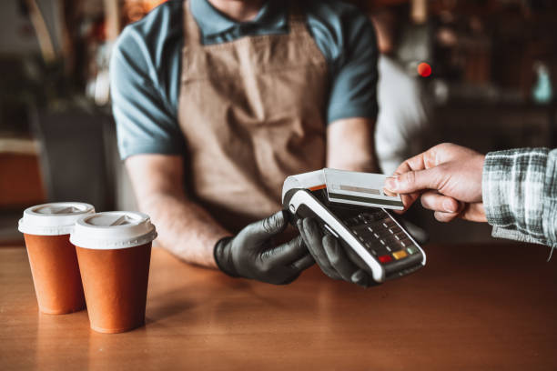 istock Credit Card Payment For Takeaway Coffee In Bar 1365199112