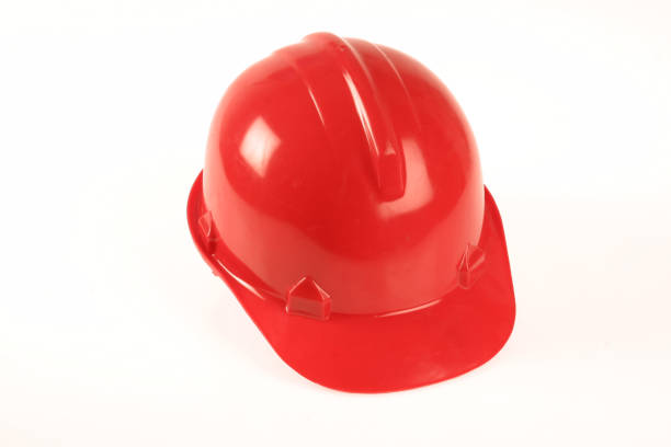 istock A red hard hat as used on construction sites, on a white background. 1365199295