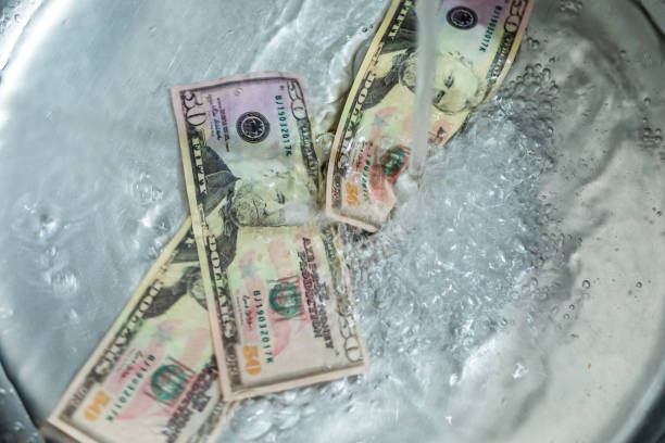 istock Wasted money going down the sink drain 1365199729