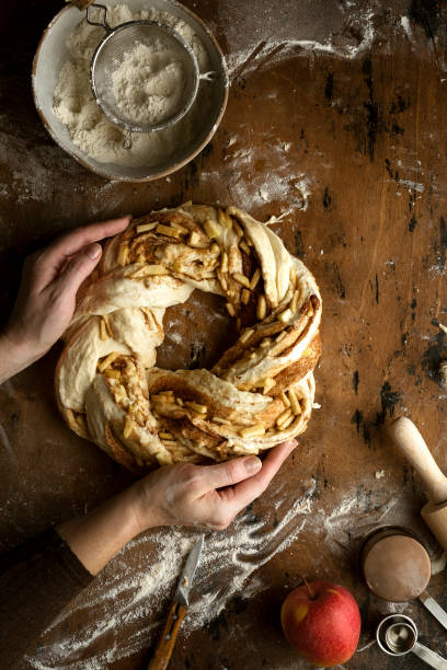 istock roll with sugar, cinnamon and apples on a wooden background 1365200938