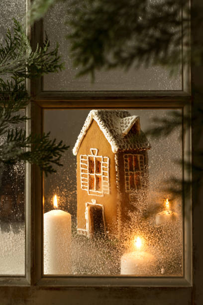 istock gingerbread house with candle view through the window 1365200946