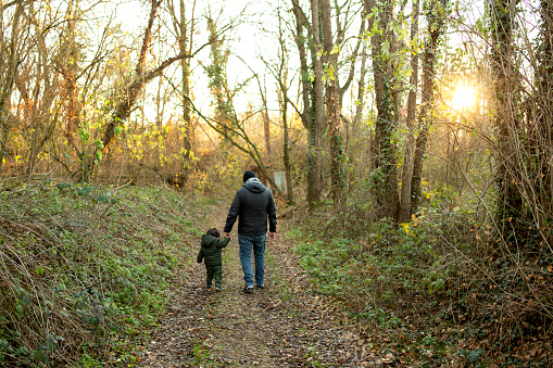 Father and son walking through the countryside