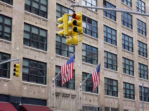 New York city Manhattan downtown traffic light USA flag on building facade
