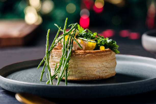 Seafood Vol-au-Vent Seafood stuffed vol-au-vent, made with prawns and crab finished with lemon pearls, samphire and parsley. Horizontal format with some copy space. food styling stock pictures, royalty-free photos & images
