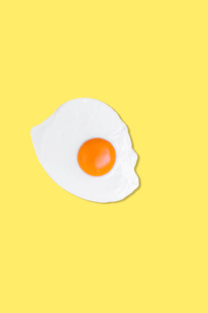 istock Creative photos of a fried chicken egg on a yellow background 1365204971