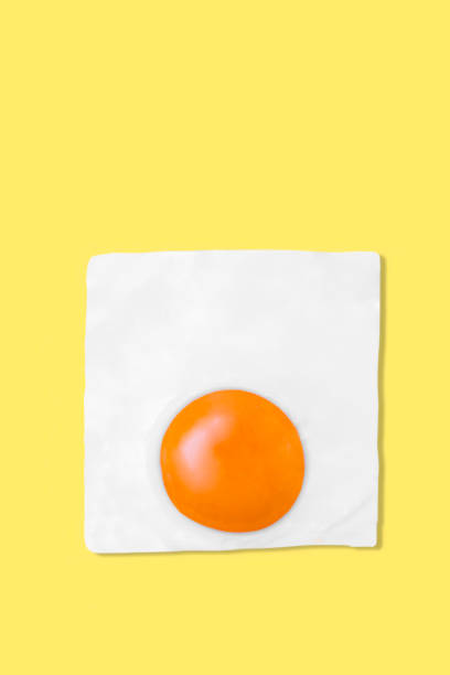 istock Creative photos of a fried chicken egg on a yellow background 1365205507