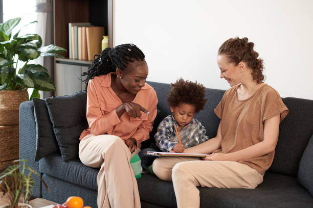 istock Mothers Looking at Drawing Kid 1365206066