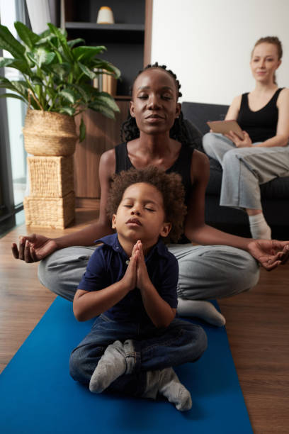 istock Boy Practicing Yoga with His Mother 1365207180
