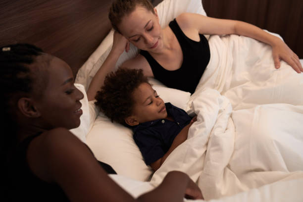 istock Mothers and Son Lying in Bed 1365207183