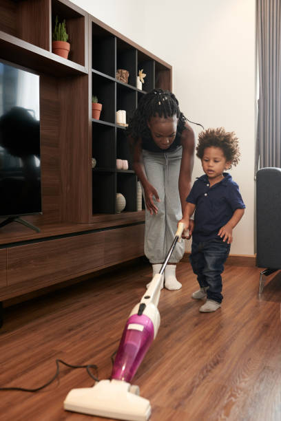 istock Vacuum Cleaning Little Boy 1365207247