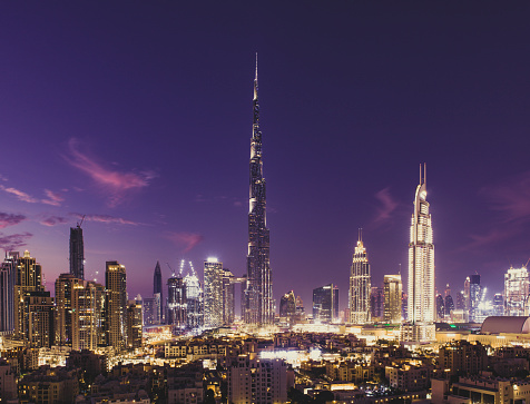 glowing dubai cityscape at night, united arab emirates.
