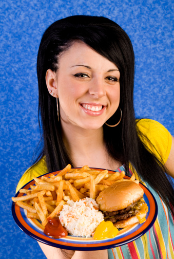 waitress with plate of burger and fries