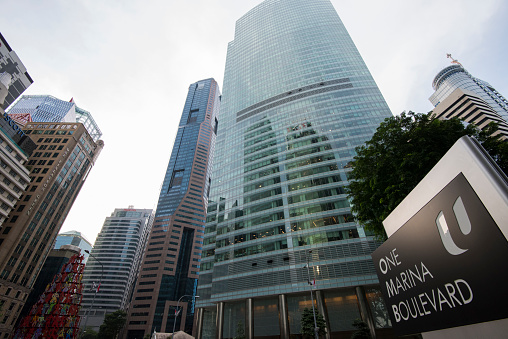 Singapore City,Singapore - September 08, 2019: Low wide-angle view looking up to modern skyscrapers in business district of Singapore City.