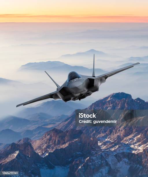 Fighter Jet Flying Over Mountains At Sunset Stock Photo - Download Image Now - Fighter Plane, Military, Aerospace Industry