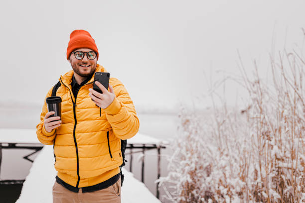 istock Man rests with hot coffee for a long walk through the snowy nature 1365212551