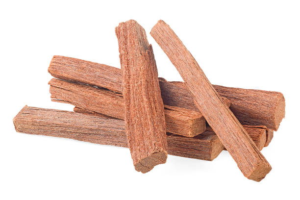 Brown sandalwood isolated on a white background. Pile of sandalwood sticks. Chandan. Brown sandalwood isolated on a white background. Pile of sandalwood sticks. Chandan. sandalwood stock pictures, royalty-free photos & images