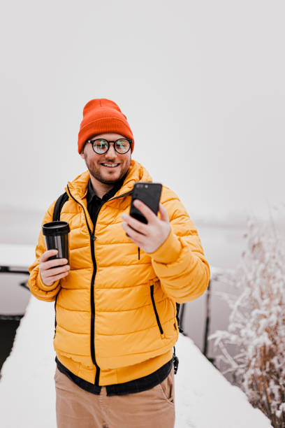 istock Man rests with hot coffee for a long walk through the snowy nature 1365214968