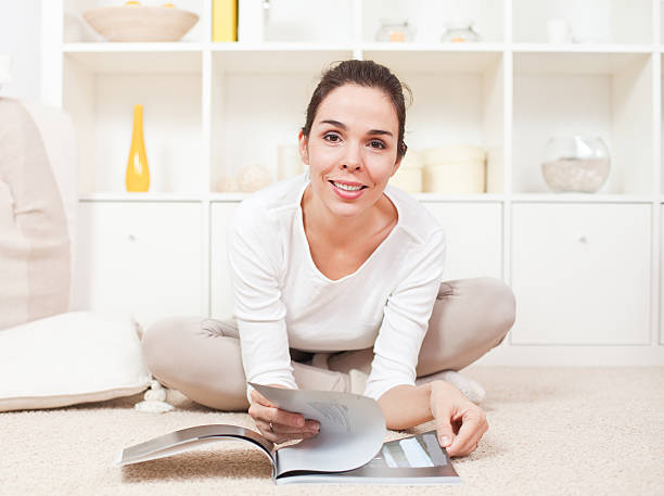 istock Beautiful young woman reading and smiling 136521531