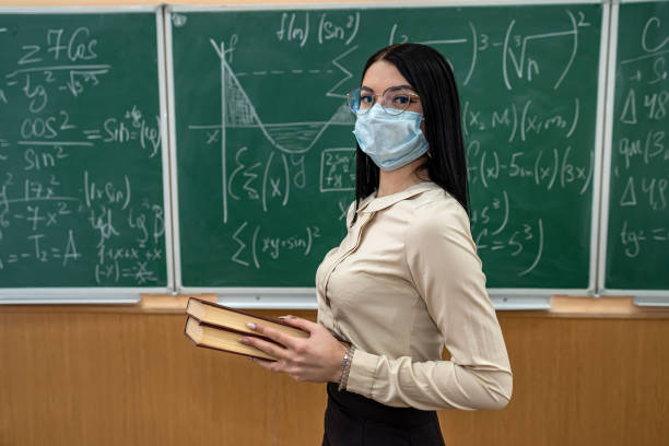 istock female teacher with mask learn math lesson at school during coronavirus pandemic 1365216594