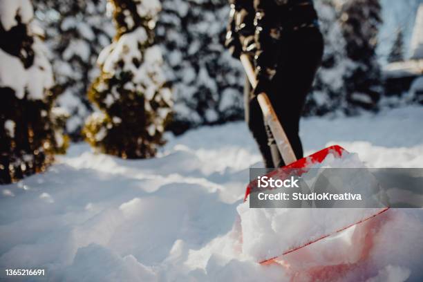 Shoveling Snow Stock Photo - Download Image Now - 20-29 Years, Adult, Adults Only