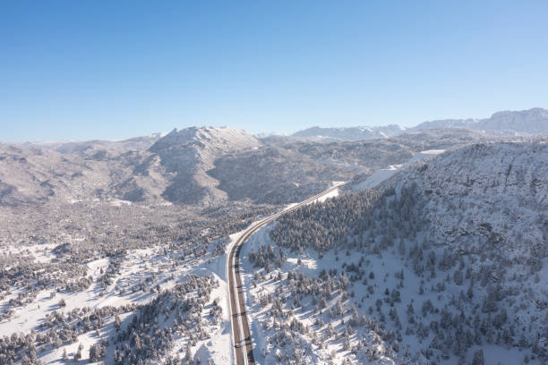 istock Snow covered mountains and highway 1365217304