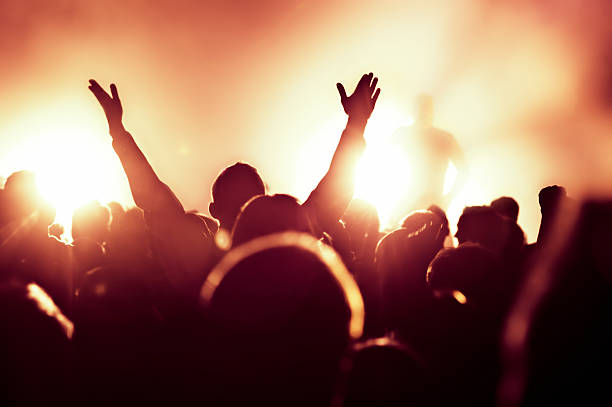 istock Man in a concert crowd with hands raised 136522099